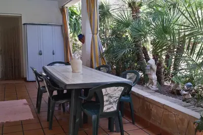 two yellow chairs sitting on a patio with a fireplace at Beach villa with pool and near BCN & TGN in Cunit