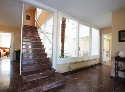 a staircase in a house with windows at Torre Vendrell con Padel in Sant Pere de Vilamajor