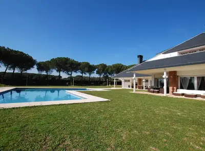 a house with a swimming pool in front of a yard at Torre Vendrell con Padel in Sant Pere de Vilamajor