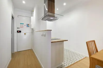 a kitchen with a refrigerator and a counter top at Stylish typical BCN flat in Barcelona