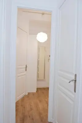 a hallway with a white door and a mirror at Apartamento Gaudí-Sant Pau in Barcelona