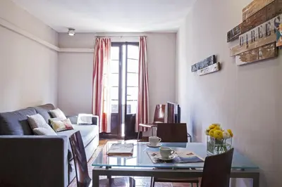 a living room with a couch and a table at AinB Las Ramblas-Guardia Apartments in Barcelona