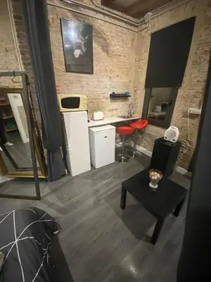 a living room with a counter and a table at Room not shared center liceu ramblas plaza Cataluña in Barcelona