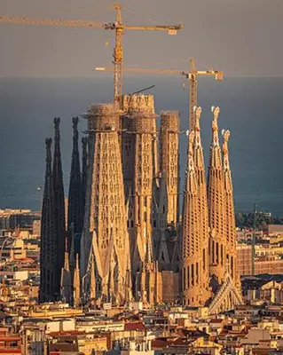 a tall building with a construction crane on top of it at Room not shared center liceu ramblas plaza Cataluña in Barcelona
