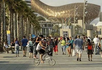 a crowd of people walking on a boardwalk with palm trees at Room not shared center liceu ramblas plaza Cataluña in Barcelona