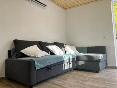 a black couch with pillows in a room at Holiday Beach Home Rincón del Mar in Cunit