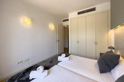 a bedroom with a bed with two towels on it at The Lonely Chimney Apartments in Barcelona