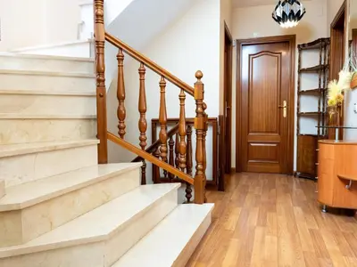 a hallway with stairs and a wooden door at Casa Serenidad: Naturaleza, Jacuzzi & Parking en Cubelles - ES-332-10 in Cubelles