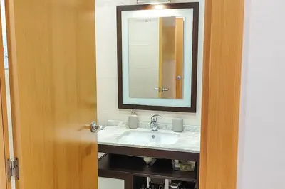 a bathroom with a sink and a mirror at Fee4Me Comfortable flat near the sea in Sant Adria de Besos