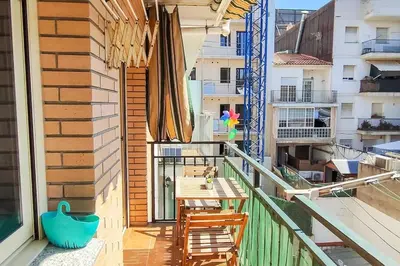 a balcony with a table and chairs on a building at Fee4Me Comfortable flat near the sea in Sant Adria de Besos