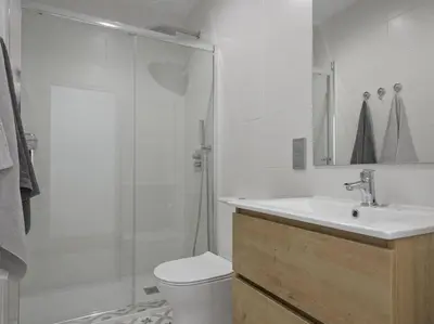 a bathroom with a shower and a toilet and a sink at La Terraza de Badalona in Badalona
