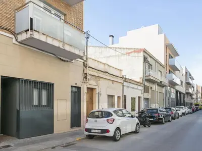 a white car parked on the side of a street at La Terraza de Badalona in Badalona