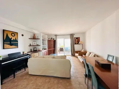 a living room with a bed and a piano at Solaui in Esplugues de Llobregat