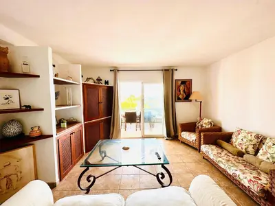 a living room with a couch and a glass table at Solaui in Esplugues de Llobregat