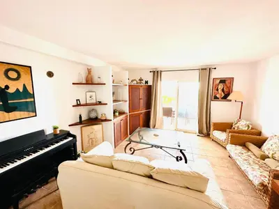 a living room with a couch and a piano at Solaui in Esplugues de Llobregat