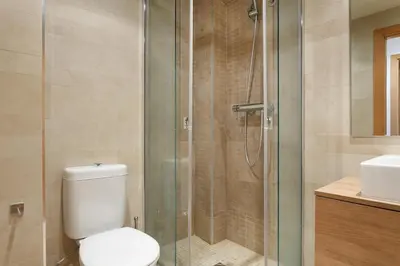 a bathroom with a toilet and a glass shower at Matarolux 1 in Mataró