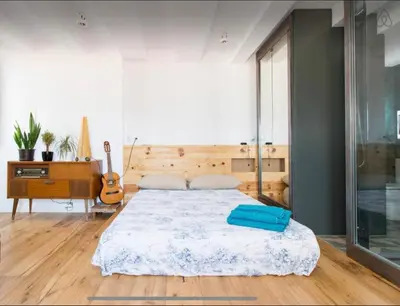 a bedroom with a bed and a desk and a guitar at Outdoor Bathtub! 360 Rooftop with Chill Out and Amazing Views! in Barcelona