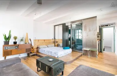 a living room with a bed and a table at Outdoor Bathtub! 360 Rooftop with Chill Out and Amazing Views! in Barcelona