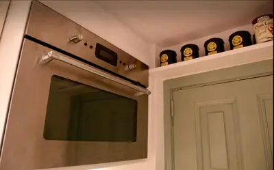 a kitchen with a door and some clocks on the wall at Outdoor Bathtub! 360 Rooftop with Chill Out and Amazing Views! in Barcelona