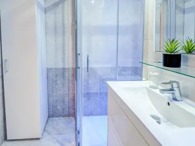 a bathroom with a sink and a shower at Casa Rainbow by Hello Homes Sitges in Sitges