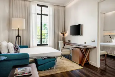 a hotel room with a bed and a desk at Cotton House Hotel, Autograph Collection in Barcelona