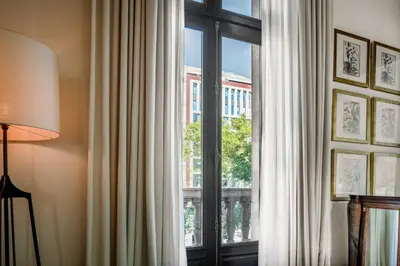 a window with a view of a building at Cotton House Hotel, Autograph Collection in Barcelona
