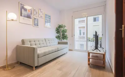 a living room with a couch and a tv at Stay U-nique Apartments Sant Nicolau in Barcelona