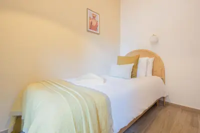 a bedroom with a bed with white sheets and pillows at Stay U-nique Apartments Sant Nicolau in Barcelona
