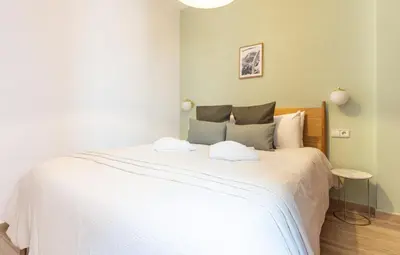 a bedroom with a large bed with white sheets at Stay U-nique Apartments Sant Nicolau in Barcelona