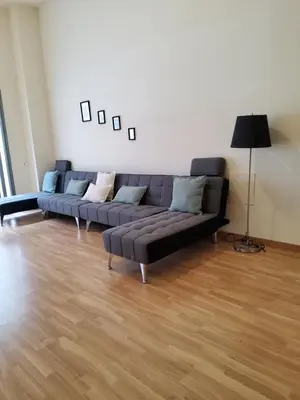 a couch in a living room with a wooden floor at SUITE apartamento in Barcelona