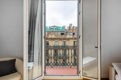 a window with a view of a building at Flateli Pelayo H3 in Barcelona
