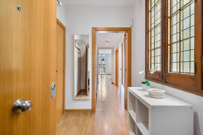 a hallway with a white counter and a mirror at Flateli Pelayo H3 in Barcelona