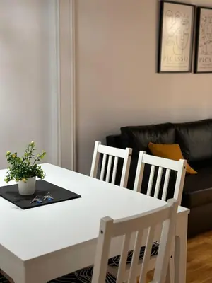a white dining room table with two chairs and a couch at Dudu life in Barcelona