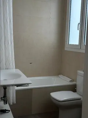 a bathroom with a tub and a toilet and a sink at Dudu life in Barcelona