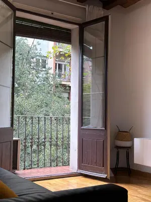 a room with a large door and a balcony at Dudu life in Barcelona