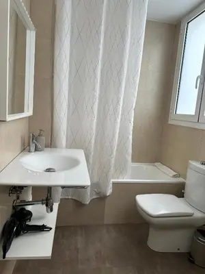 a bathroom with a sink and a toilet and a window at Dudu life in Barcelona
