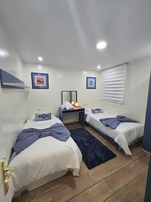 a room with three beds and a table in it at Alojamiento Entero Moderno En Barcelona Terrassa in Terrassa