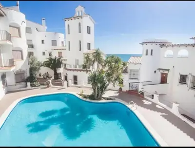 a large swimming pool in front of a building at Loft espectacular vista al mar in Sitges