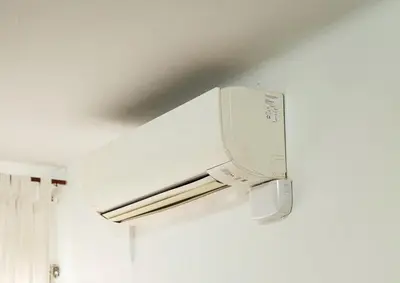 a white microwave oven hanging on a wall at Casa a pasos de Las Ramblas in Barcelona