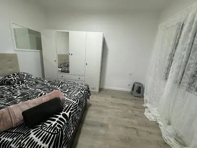 a bedroom with a bed with a zebra print blanket at Habitacion Sagrada Familia in Barcelona