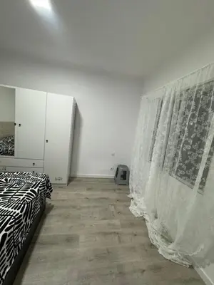 a white room with a bed and a curtain at Habitacion Sagrada Familia in Barcelona