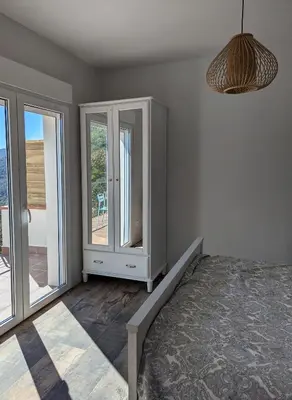 a bedroom with a bed and two windows at Apartamento en medio de la naturaleza, con fantásticas vistas in Sant Cugat del Vallès