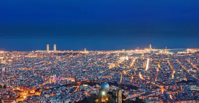 an aerial view of a city at night at Apartamento en medio de la naturaleza, con fantásticas vistas in Sant Cugat del Vallès
