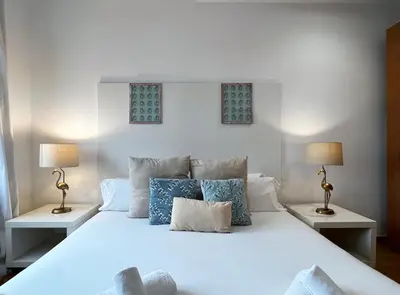 a bedroom with a white bed with two lamps at Stay U-nique Apartments Rambla Catalunya in Barcelona
