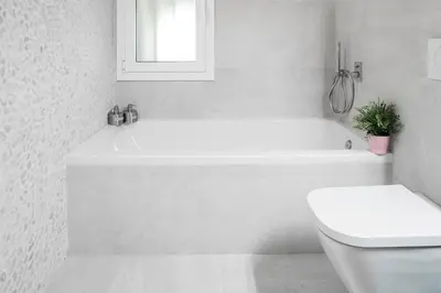 a white bathroom with a tub and a toilet at Magic Apartment with Private Terrace in Barcelona