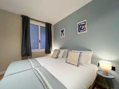 a bedroom with a large white bed with a window at Stay U-nique Apartment Castanyer in Barcelona