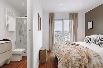 a bedroom with a bed and a bathroom with a shower at Casa Ciudadela in Barcelona