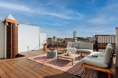 a balcony with two chairs and a table on a roof at Casa Ciudadela in Barcelona