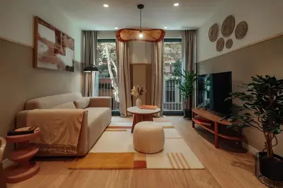 a living room with a couch and a tv at Casa Carlit - 1 bedroom apartment near Plaza Tetuán in Barcelona