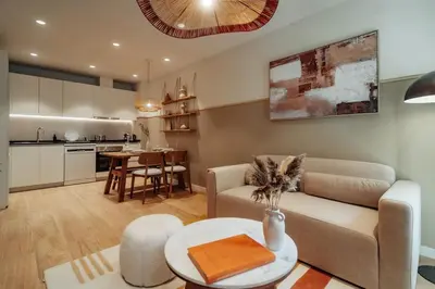 a living room with a couch and a table at Casa Carlit - 1 bedroom apartment near Plaza Tetuán in Barcelona